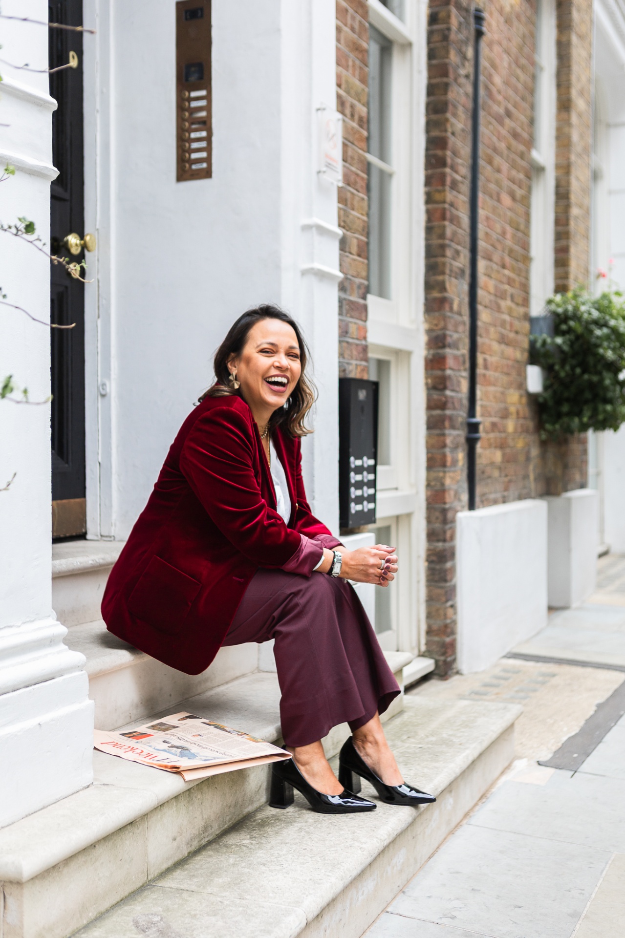 Leticia Fonseca laughing on the steps of a London townhouse